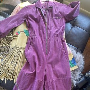 g. Pellini Corduroy jumpsuit with sinched waist and zippers.